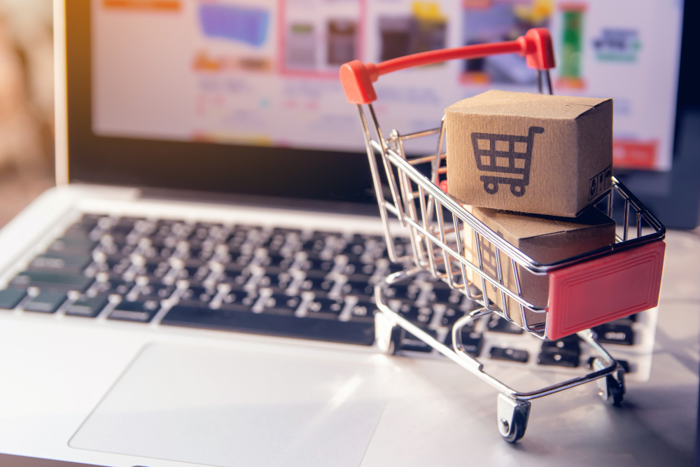 shopping-online-concept-parcel-paper-cartons-with-shopping-cart-logo-trolley-laptop-keyboard-shopping-service-online-web-offers-home-delivery